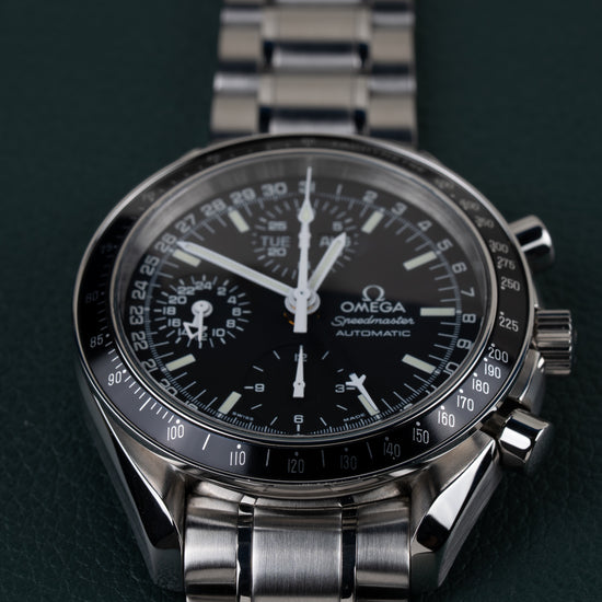 Omega Speedmaster Day-Date 3520.50 - close-up frontaal onder een andere hoek met de dag-datumaanduiding en drukknoppen