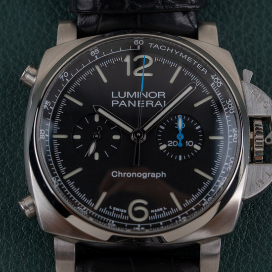 Panerai Luminor Chronograph PAM01109 - frontale close-up van de zwarte wijzerplaat met tachymeterschaal en drukknoppen